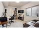 Comfortable home office with desk space, a large window, and a cozy leather couch at 2862 E 103Rd Ave, Denver, CO 80229
