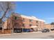 Exterior view of a brick apartment building with street parking available at 155 S Pennsylvania St # 205, Denver, CO 80209