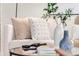 Close-up of a white sofa with decorative pillows and glass table at 155 S Pennsylvania St # 205, Denver, CO 80209