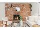 Inviting living room boasting a brick fireplace, modern furniture, and contemporary accents at 155 S Pennsylvania St # 205, Denver, CO 80209