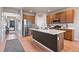 Stylish kitchen with stainless steel appliances, a large island, and modern fixtures at 244 Chipeta Way, Lochbuie, CO 80603