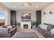 Inviting living room with a cozy fireplace, plush seating, and abundant natural light at 244 Chipeta Way, Lochbuie, CO 80603