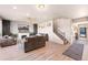 Spacious living room featuring hard wood floors, a cozy fireplace, and comfortable seating at 244 Chipeta Way, Lochbuie, CO 80603