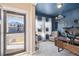 Inviting home office bathed in natural light with a comfortable chair and modern desk setup at 244 Chipeta Way, Lochbuie, CO 80603