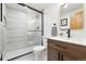 Modern bathroom featuring a glass-enclosed shower, wood-look vanity, and stylish fixtures at 31 Wild Tiger Ln, Boulder, CO 80302