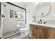 Modern bathroom featuring a glass shower, sleek fixtures, and stylish vanity with a round mirror at 31 Wild Tiger Ln, Boulder, CO 80302