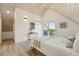 Bright bedroom with vaulted ceilings, skylights and modern decor with doors to a balcony at 31 Wild Tiger Ln, Boulder, CO 80302