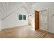 Large room with hardwood floors, white ceiling and an open doorway to a full bathroom at 31 Wild Tiger Ln, Boulder, CO 80302