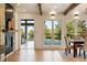 Open dining room with a stone fireplace, light wood floors, and a view to the outside deck at 31 Wild Tiger Ln, Boulder, CO 80302