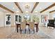 Bright dining room featuring wood beams, a view of the outdoors and stylish furniture on an area rug at 31 Wild Tiger Ln, Boulder, CO 80302