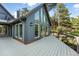 Stunning exterior with multiple windows, a deck, and dark blue painted wood siding at 31 Wild Tiger Ln, Boulder, CO 80302