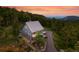 An angled outdoor shot of a home surrounded by trees and a driveway at 31 Wild Tiger Ln, Boulder, CO 80302