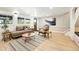 Bright living room with modern decor, stylish rug, and large windows offering plenty of natural light at 31 Wild Tiger Ln, Boulder, CO 80302