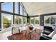 Bright living room with vaulted wood ceilings, large windows with a view, and modern furniture on an area rug at 31 Wild Tiger Ln, Boulder, CO 80302