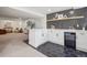 Finished basement bar features a sleek design with modern cabinetry, open shelving, and a beverage cooler at 1057 English Sparrow Trl, Highlands Ranch, CO 80129