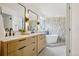 Elegant bathroom features double vanities, modern mirrors, and a luxurious soaking tub at 1057 English Sparrow Trl, Highlands Ranch, CO 80129