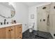 Modern bathroom featuring black fixtures, a marble countertop, and a glass-enclosed shower at 1057 English Sparrow Trl, Highlands Ranch, CO 80129