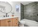 Well-lit bathroom with a modern vanity, stylish mirror, and tiled shower/tub combo, offering a serene and functional space at 1057 English Sparrow Trl, Highlands Ranch, CO 80129