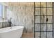 Beautiful bathroom featuring a modern soaking tub and a sleek glass-enclosed shower at 1057 English Sparrow Trl, Highlands Ranch, CO 80129