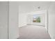 Bright bedroom featuring a large window, neutral decor, and ample space for relaxation and personalization at 1057 English Sparrow Trl, Highlands Ranch, CO 80129