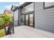 Modern home featuring a gray exterior, large windows, and an outdoor deck providing scenic views at 1057 English Sparrow Trl, Highlands Ranch, CO 80129