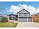 Beautiful two-story home with gray siding, brick accents, and a well-manicured front lawn at 1057 English Sparrow Trl, Highlands Ranch, CO 80129