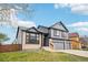 Charming two-story home with gray siding, brick accents, and a well-maintained lawn at 1057 English Sparrow Trl, Highlands Ranch, CO 80129