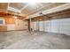 Spacious unfinished garage with multiple doors, exposed ceiling framing, offering ample storage and workspace at 1057 English Sparrow Trl, Highlands Ranch, CO 80129