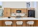 Bright kitchen showcasing a spacious island with seating, sleek countertops, and modern appliances, offering both style and functionality at 1057 English Sparrow Trl, Highlands Ranch, CO 80129