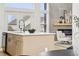 Modern kitchen island with a sink, complemented by stylish fixtures and cabinetry and a fireplace, perfect for cooking and socializing at 1057 English Sparrow Trl, Highlands Ranch, CO 80129
