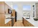 Modern kitchen featuring ample counter space, stainless steel appliances, and natural wood cabinetry, combining style and practicality at 1057 English Sparrow Trl, Highlands Ranch, CO 80129