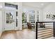 Bright living room featuring hardwood floors, high ceilings, and abundant natural light at 1057 English Sparrow Trl, Highlands Ranch, CO 80129