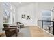 Bright and airy living room with large windows, hardwood floors, and neutral decor at 1057 English Sparrow Trl, Highlands Ranch, CO 80129