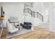 Open-concept living room with hardwood floors, a staircase with modern railing, and ample seating at 1057 English Sparrow Trl, Highlands Ranch, CO 80129