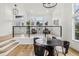 Bright living room showcasing a stylish seating area and modern staircase with black rails, exuding elegance and comfort at 1057 English Sparrow Trl, Highlands Ranch, CO 80129