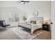 Serene bedroom featuring a comfortable bed, stylish decor, and large windows, creating a tranquil retreat for relaxation and rest at 1057 English Sparrow Trl, Highlands Ranch, CO 80129