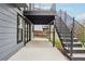 View of the concrete patio and staircase leading to a second-story deck of the exterior of the home at 1057 English Sparrow Trl, Highlands Ranch, CO 80129