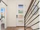 Bright entryway with modern frosted glass door and staircase at 1555 Perry St, Denver, CO 80204