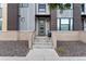 Townhome entrance with modern gray door and stone accents at 1555 Perry St, Denver, CO 80204