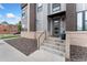 Townhome entrance with modern gray door and stone accents at 1555 Perry St, Denver, CO 80204