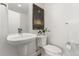 Clean powder room with floating sink and toilet at 1555 Perry St, Denver, CO 80204