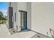 Back entrance featuring a glass door, modern exterior, and fresh landscaping at 1372 Lowell Blvd # 2, Denver, CO 80204
