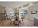 Bright, open living area featuring a dining space, fireplace, staircase, and comfortable seating with modern decor at 1372 Lowell Blvd # 2, Denver, CO 80204