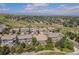 Gorgeous aerial view of a neighborhood with lush landscaping, walking trails, and mountain views at 10994 Shadowbrook Cir, Highlands Ranch, CO 80130