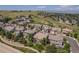 An aerial view of a residential neighborhood surrounded by grassy hillsides at 10994 Shadowbrook Cir, Highlands Ranch, CO 80130