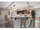 Finished basement wet bar features modern lighting, countertop seating, stylish decor, and updated cabinetry at 10994 Shadowbrook Cir, Highlands Ranch, CO 80130