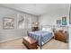 Cozy bedroom with natural light, showcasing a metal bed frame and classic wooden furniture at 10994 Shadowbrook Cir, Highlands Ranch, CO 80130
