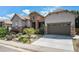 Beautiful home with a stone facade, manicured lawn, and an attached two car garage at 10994 Shadowbrook Cir, Highlands Ranch, CO 80130