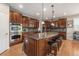 Gourmet kitchen with custom cabinets, granite countertops, and stainless steel appliances at 10994 Shadowbrook Cir, Highlands Ranch, CO 80130