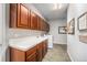 Convenient laundry room with white appliances, cabinetry, and ample counter space at 10994 Shadowbrook Cir, Highlands Ranch, CO 80130